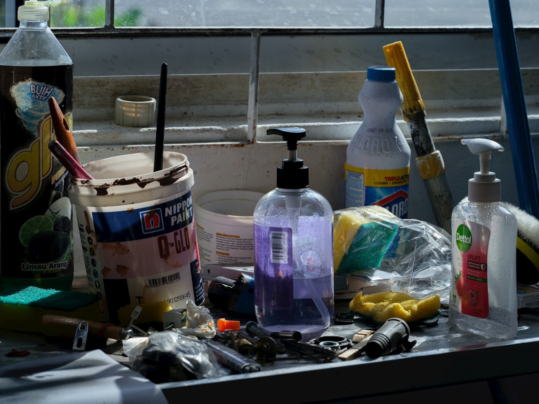 Kitchen cleaning products and sponges on shelf liner