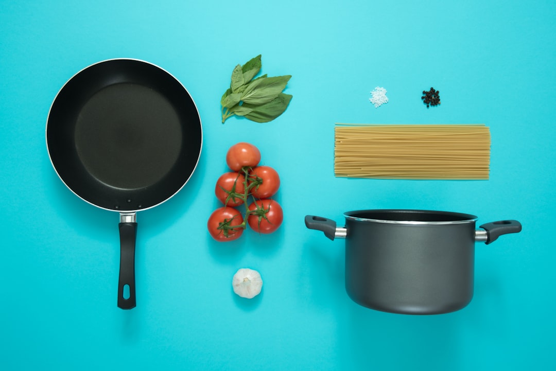 Kitchen utensils and cooking tools arranged in flat lay