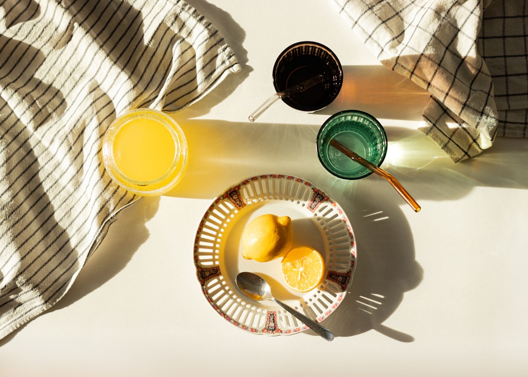 Glass of fresh orange juice on sunny morning kitchen counter