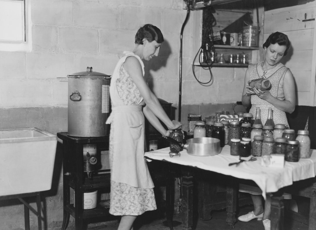 A woman preserving fruit in a home kitchen