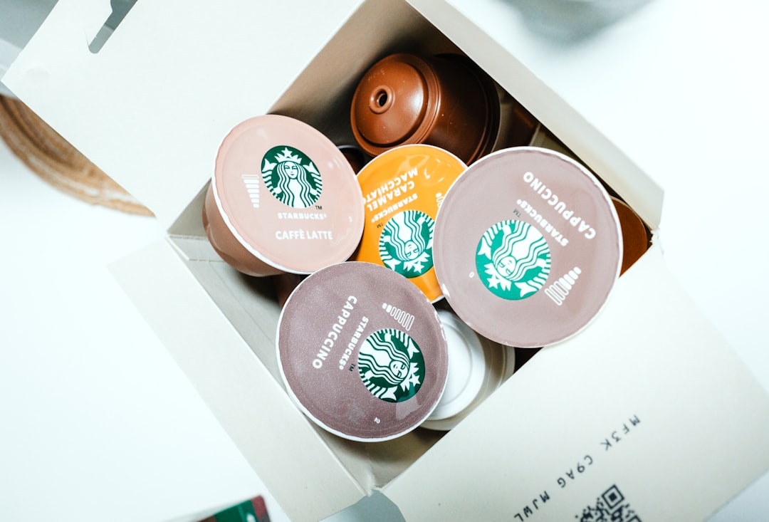 An open box overflowing with assorted coffee pods waiting to be sorted