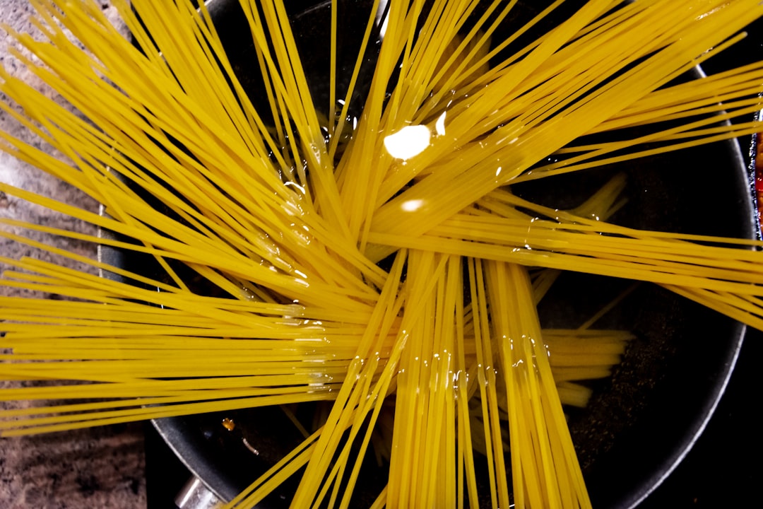 Spaghetti soaking in a deep pot of water