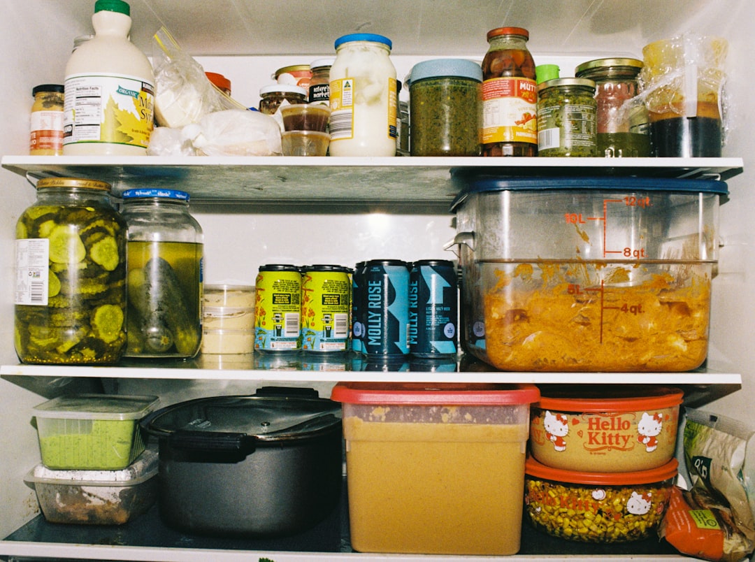 A colorful, organized refrigerator interior with fresh produce visible on every shelf