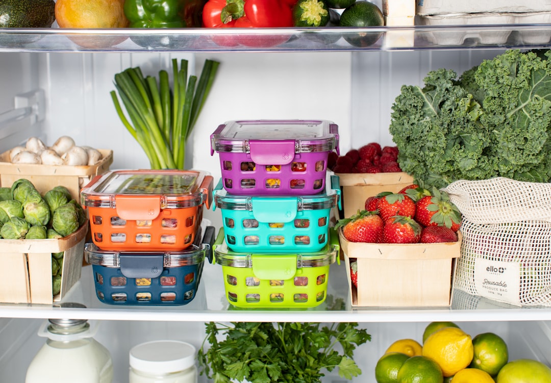 Storage bins organizing food in refrigerator