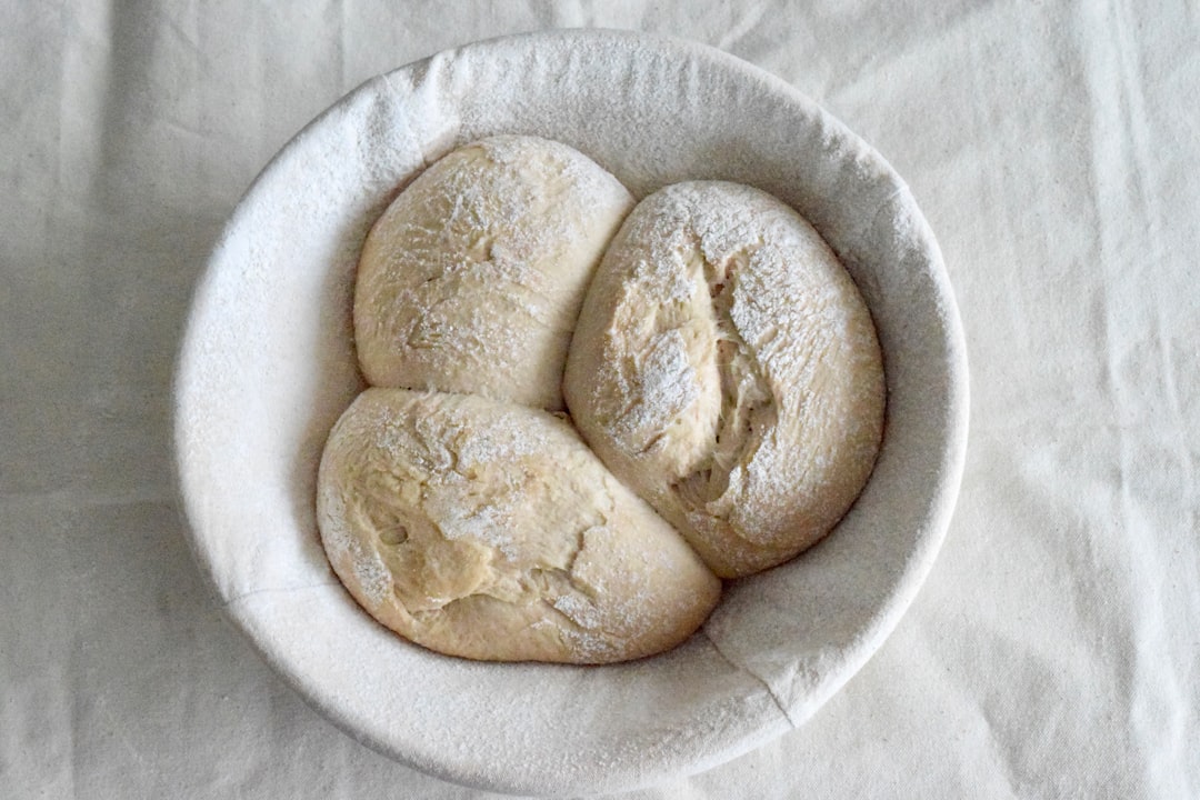Bread dough rising in a floured bowl