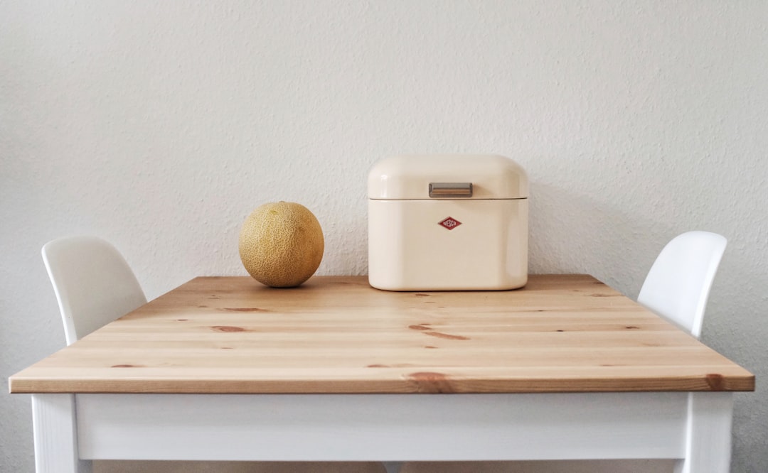 Large airtight flour and dry goods containers on a kitchen shelf