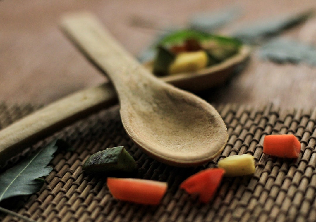 Turmeric powder in a wooden spoon