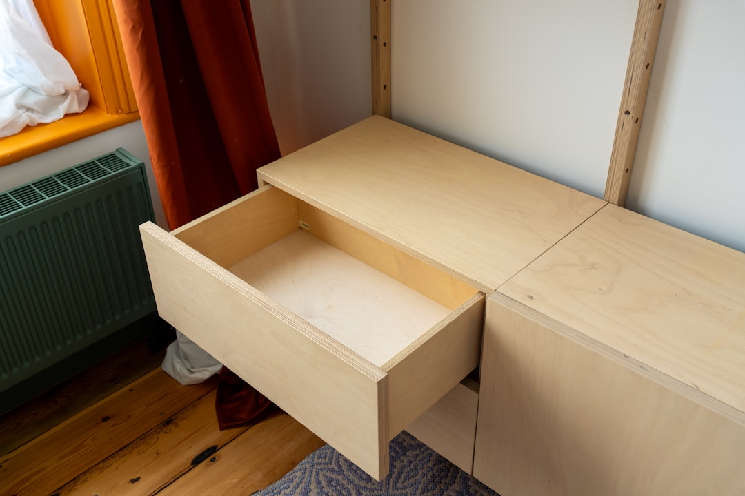 Pull-out cabinet drawer showing organized pots and pans on sliding shelves