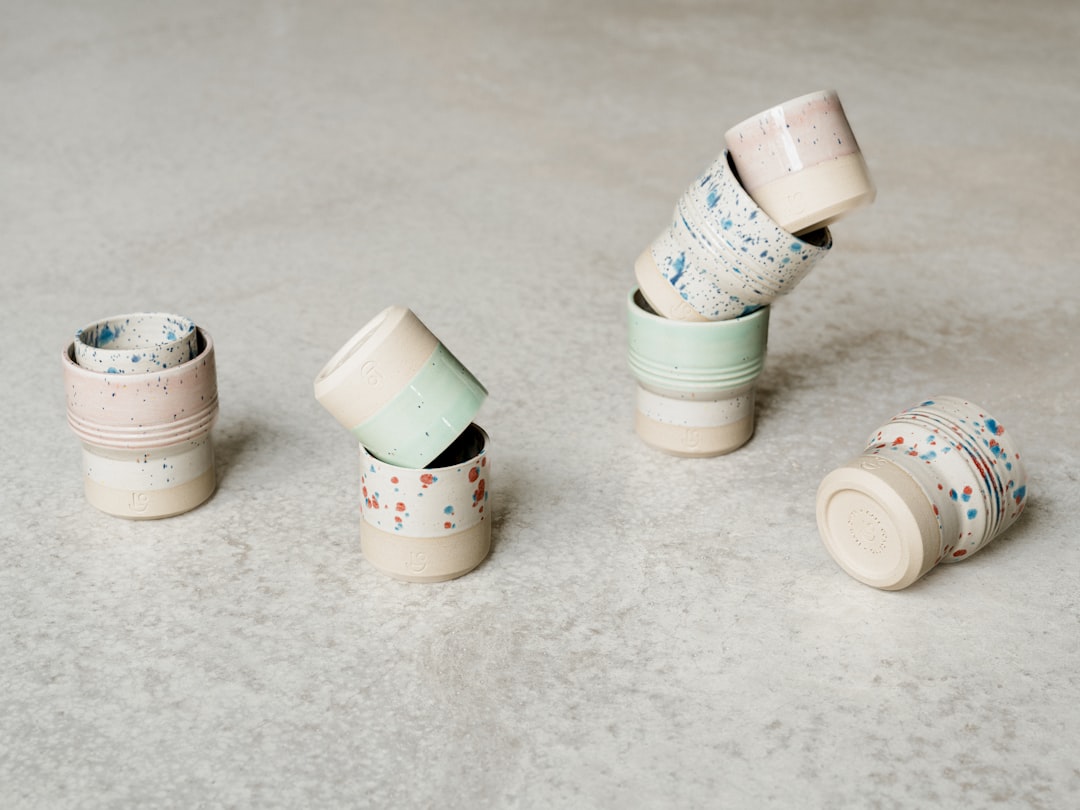Collection of colorful insulated tumblers lined up on a counter