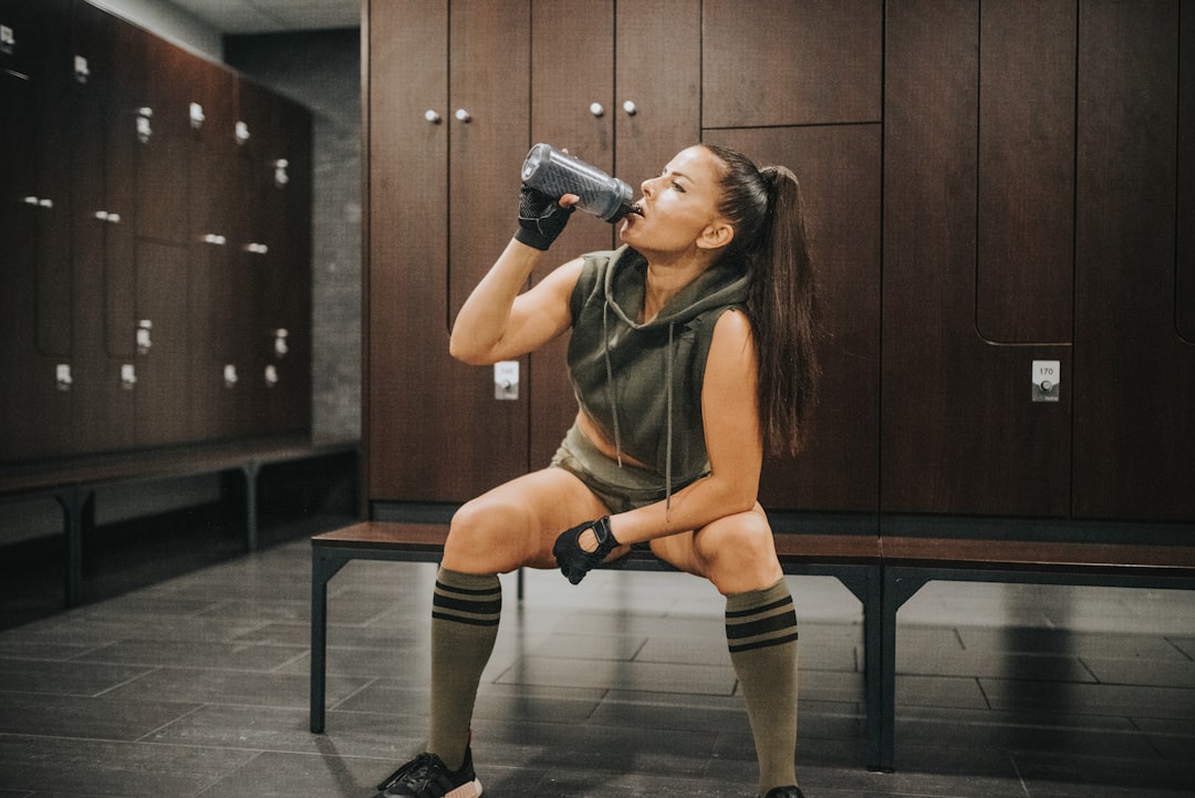 Woman drinking from a water bottle after a workout