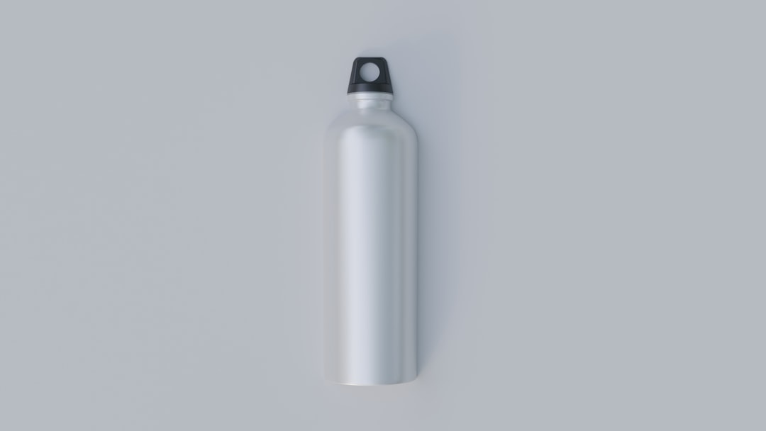 Stainless steel insulated water bottle on a wooden surface