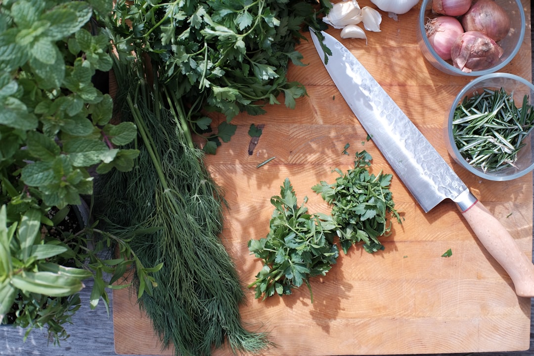 Fresh herbs laid out on a wooden cutting board