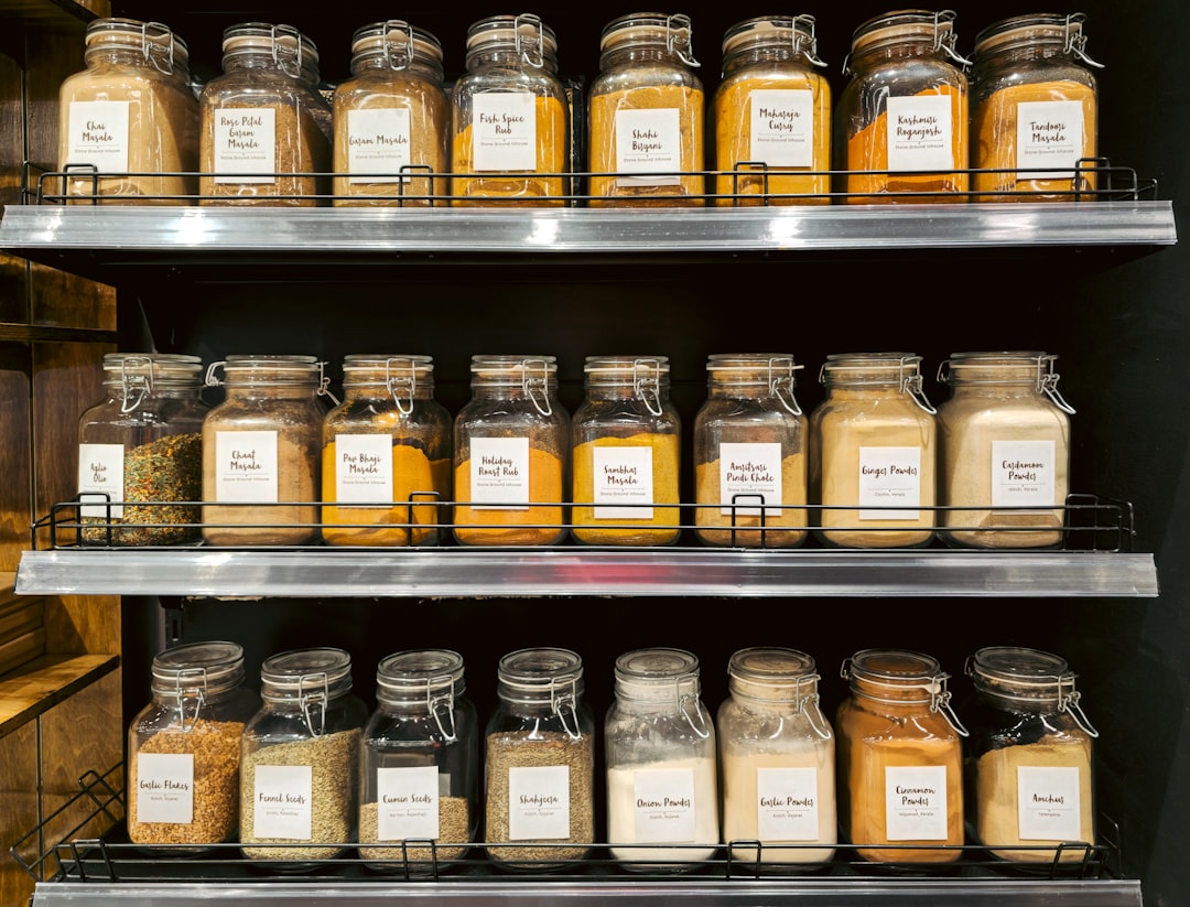 Glass spice jars with labels arranged in a row