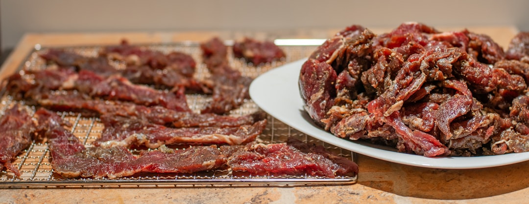 Homemade beef jerky strips drying on racks