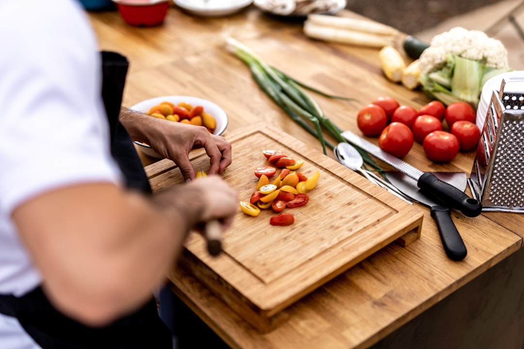 Prepped vegetables and herbs chopped on a cutting board
