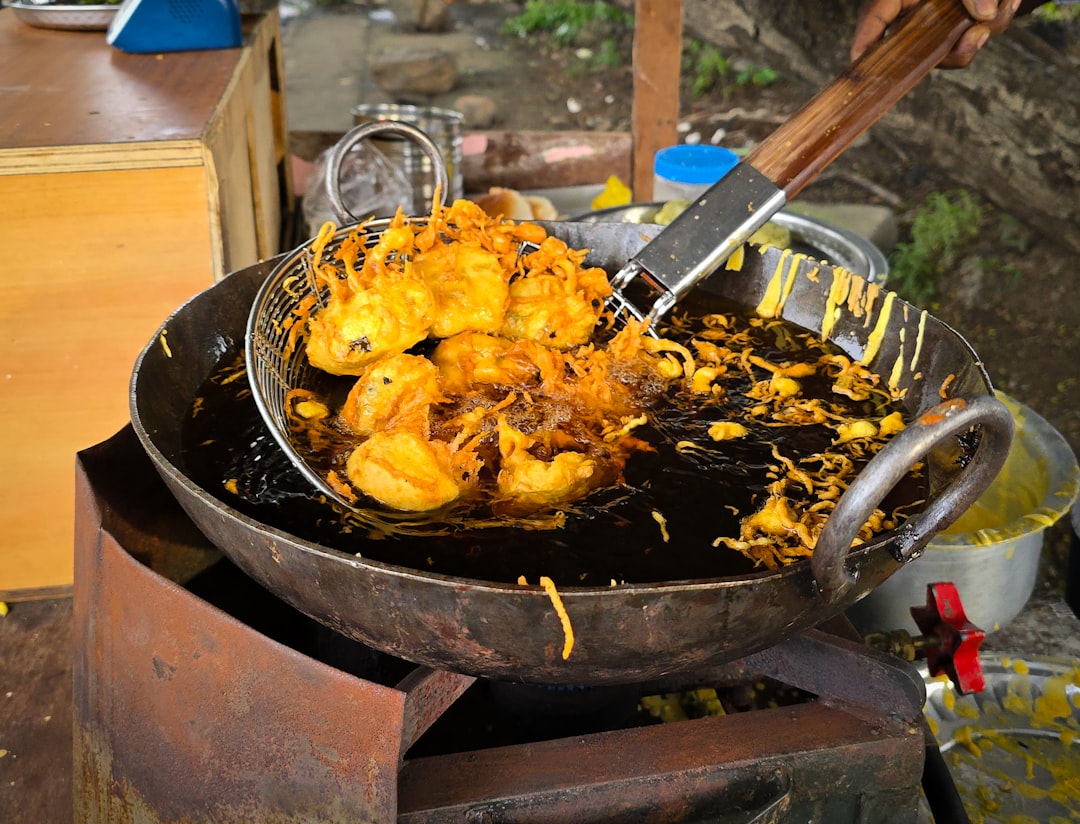 Cooking oil being poured into a hot pan