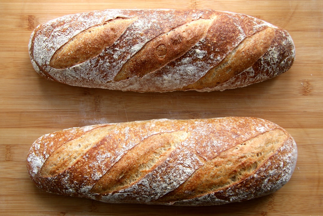Fresh baked crusty loaves on a wooden board