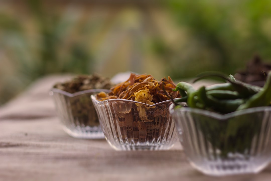 Small glass bowls of spices, herbs, and fresh chilies