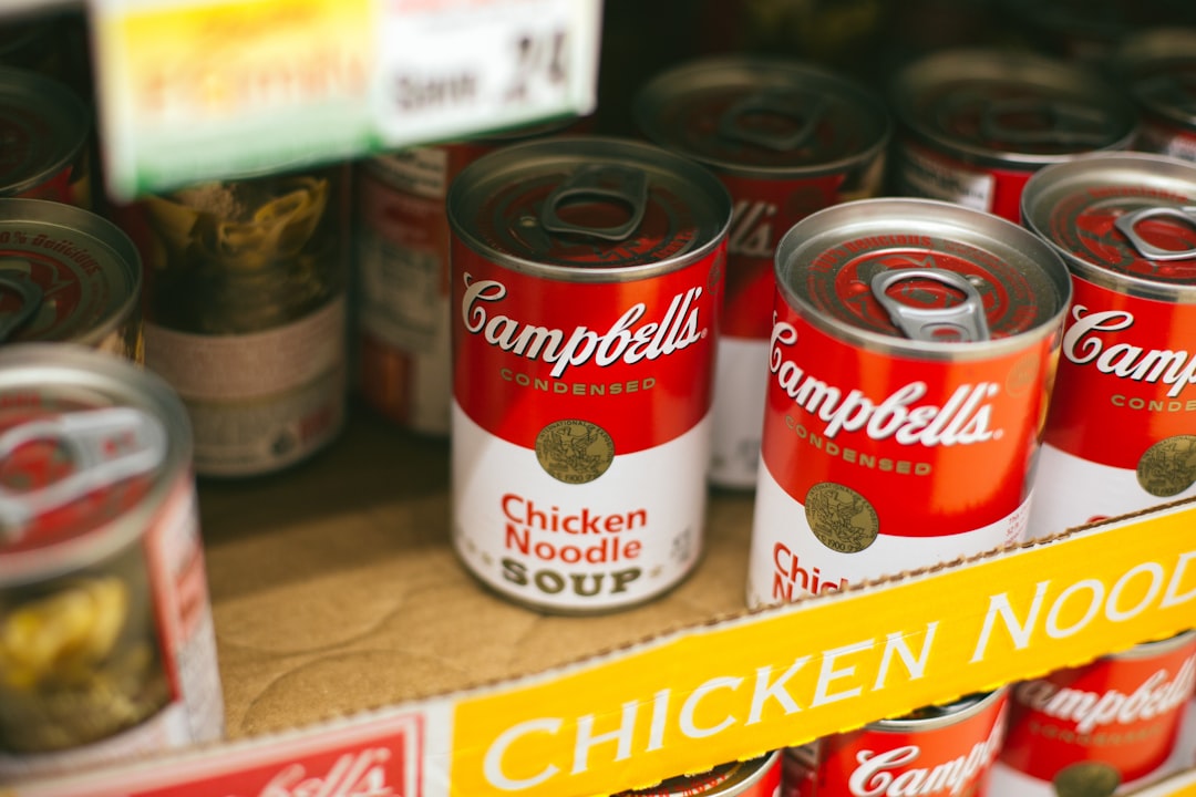 Rows of canned tomatoes and jarred goods stored on shelves