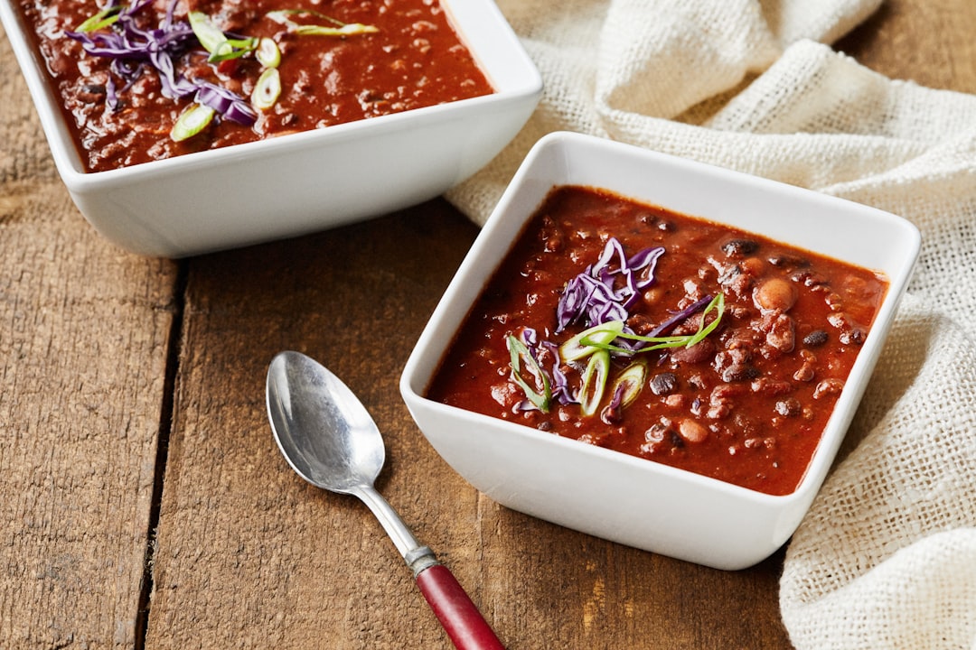 A bowl of chili garnished and ready to eat
