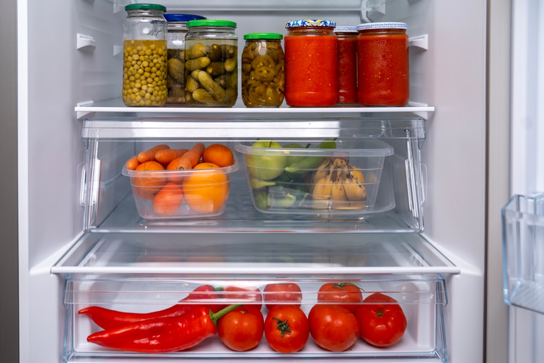 Condiment bottles and jars organized on refrigerator door shelves