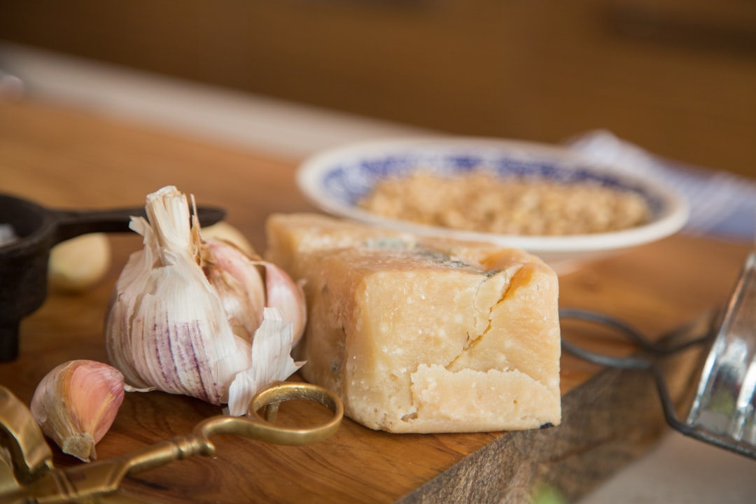 Wedge of parmesan cheese on a wooden board