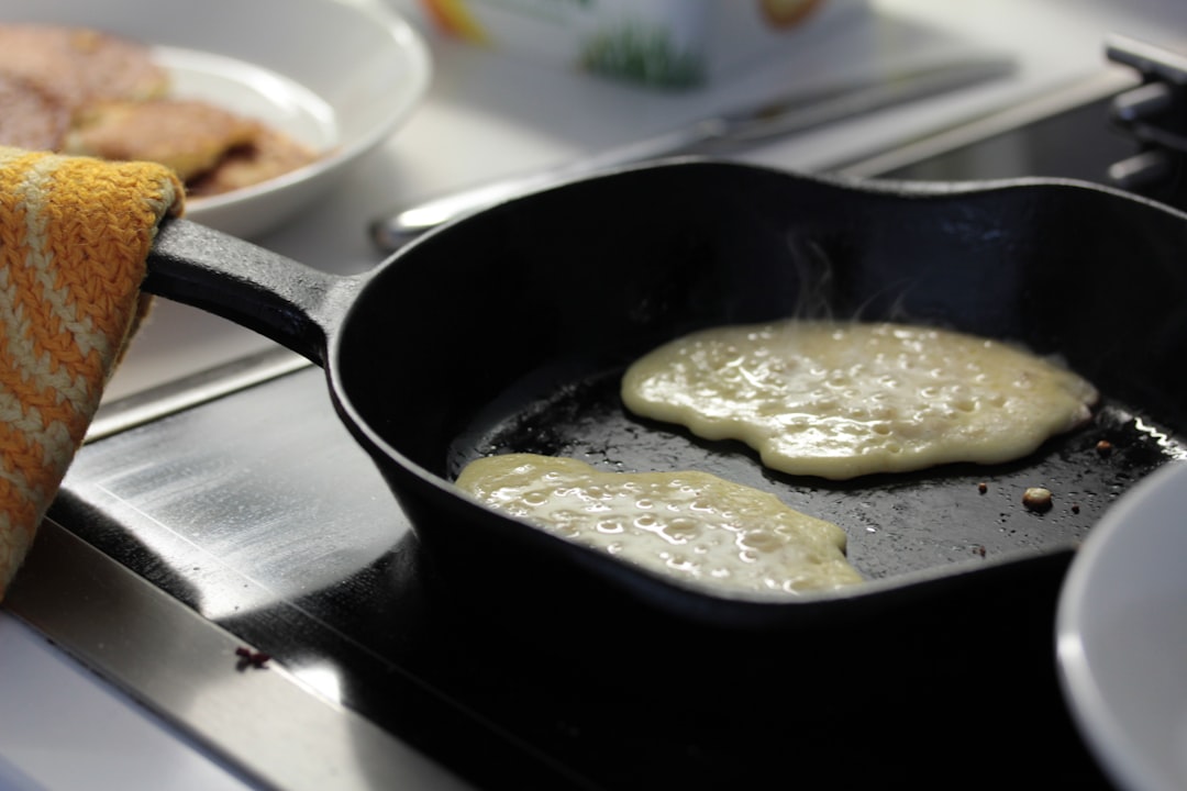 Golden pancakes cooking on a griddle surface