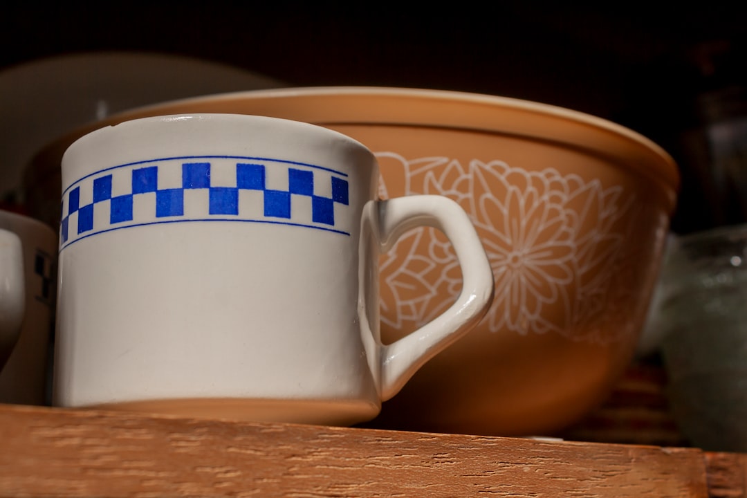 A coffee mug kept within easy reach on a neatly arranged kitchen shelf