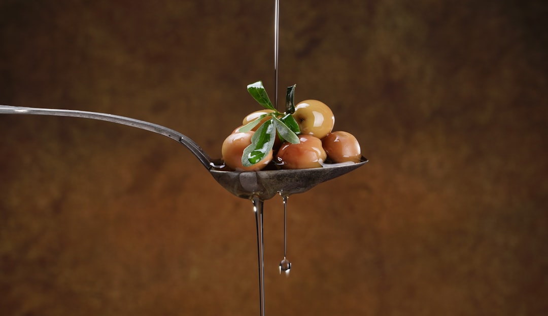 Golden olive oil drizzled over a fresh salad just before serving