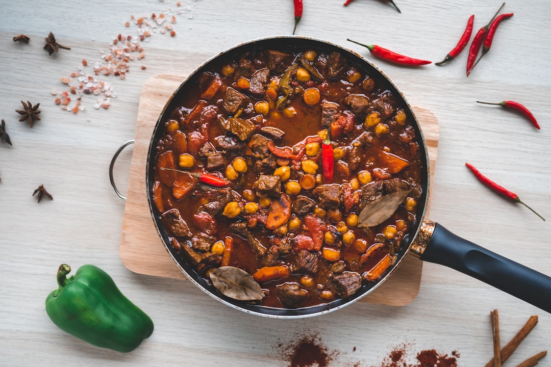 Beef stew simmering in a pot on the stove
