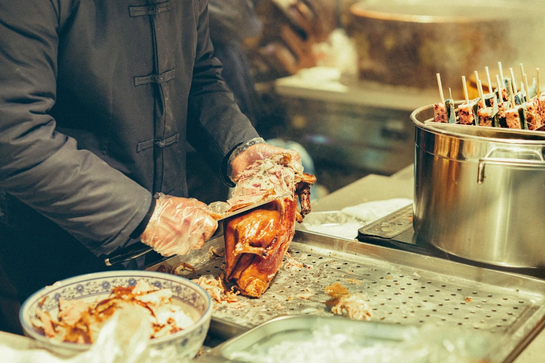 Raw whole chicken being prepped on a kitchen counter