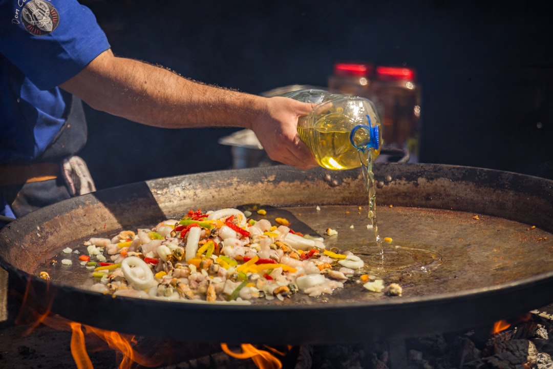 Chef deglazing a pan with wine, steam rising as fond dissolves