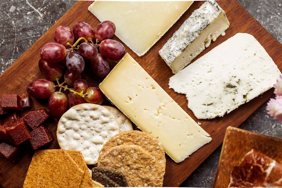 Wooden board styled with cheese, grapes and crackers