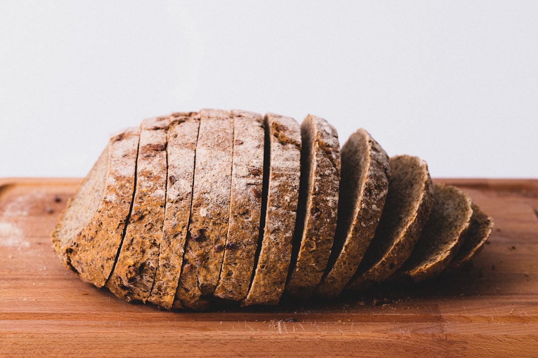 Sliced dark bread loaf on a wooden board