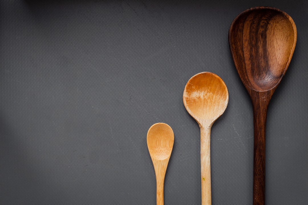Wooden kitchen utensils arranged on a wooden surface