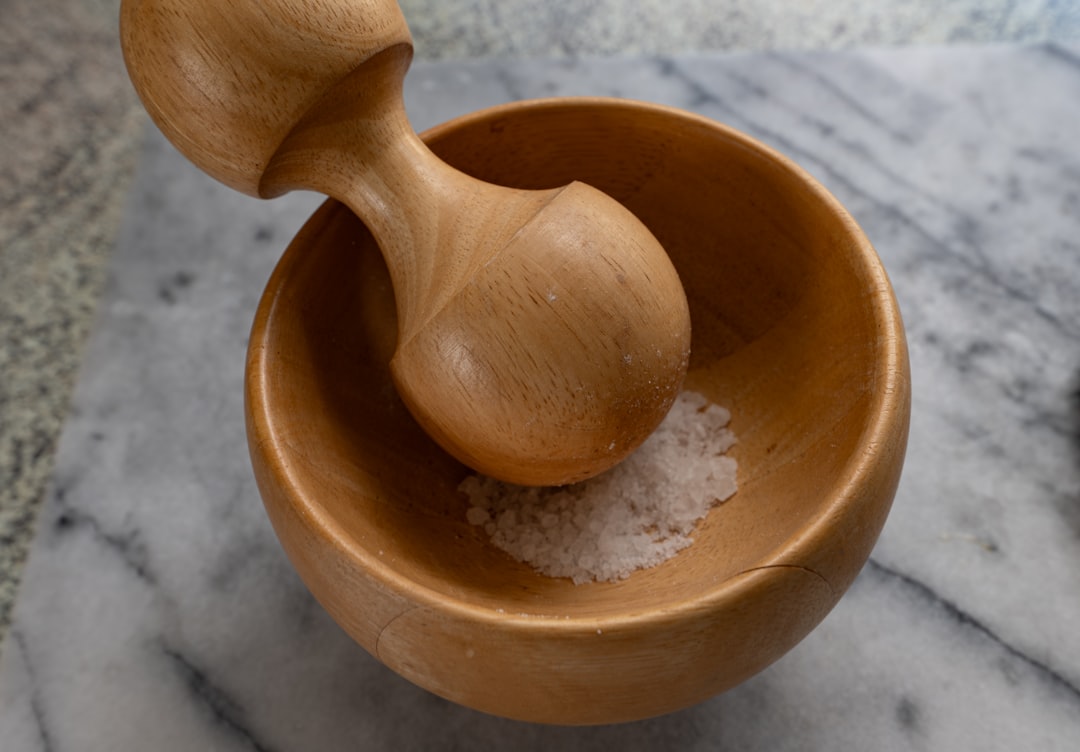 Wooden salt cellar kept within reach for pinching salt while cooking
