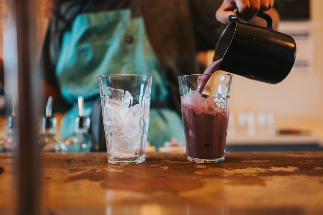 Pouring a fresh smoothie from a blender pitcher