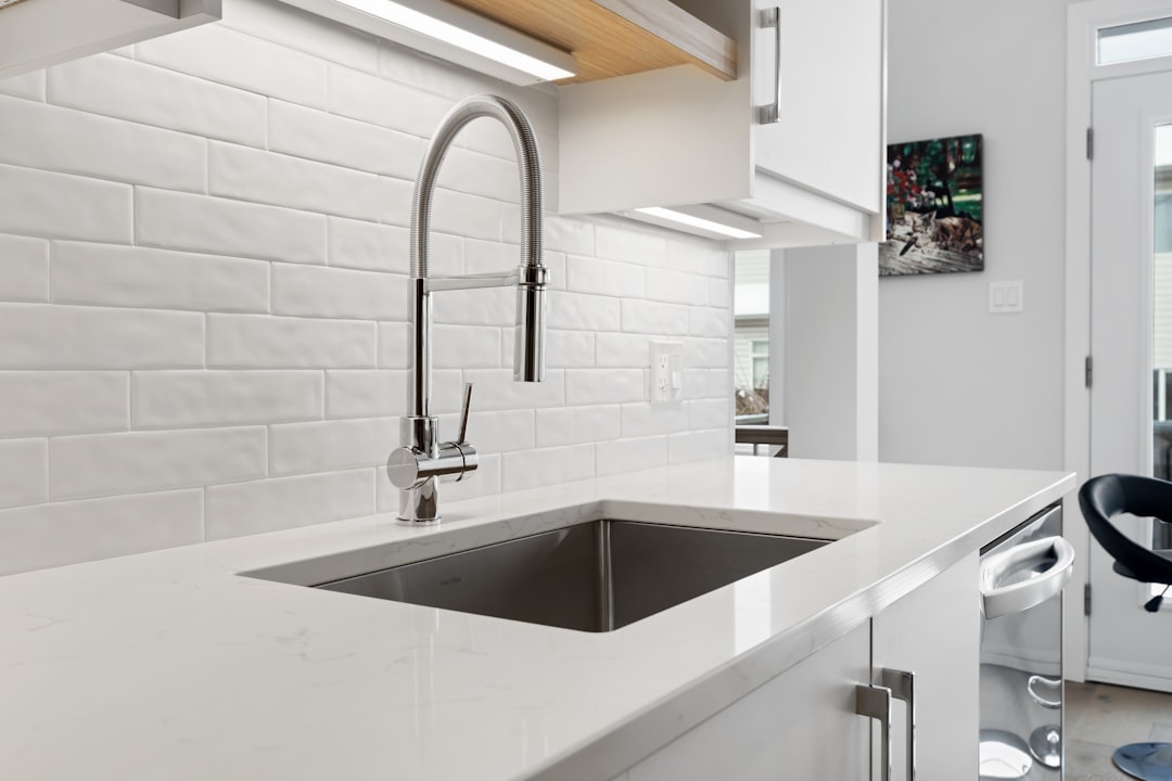 Under-sink area showing plumbing pipes that make organization challenging
