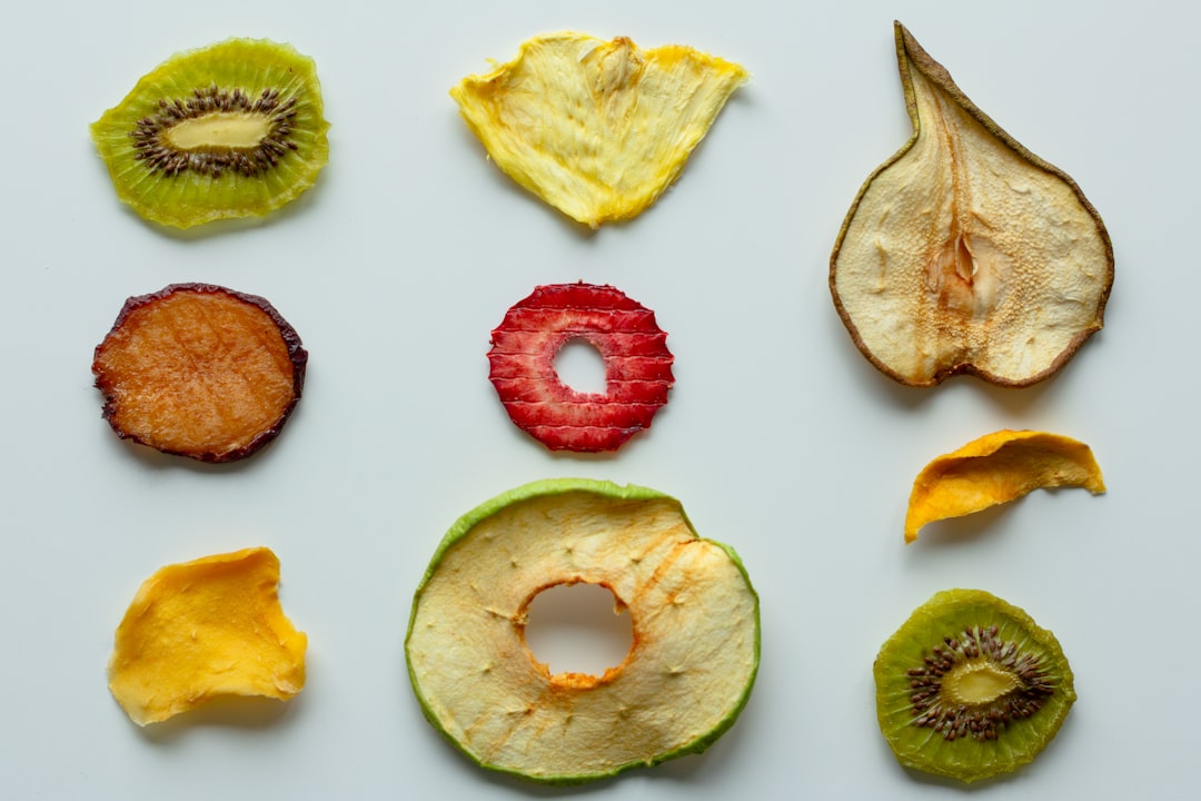 Chewy dried apple rings arranged on a wooden board