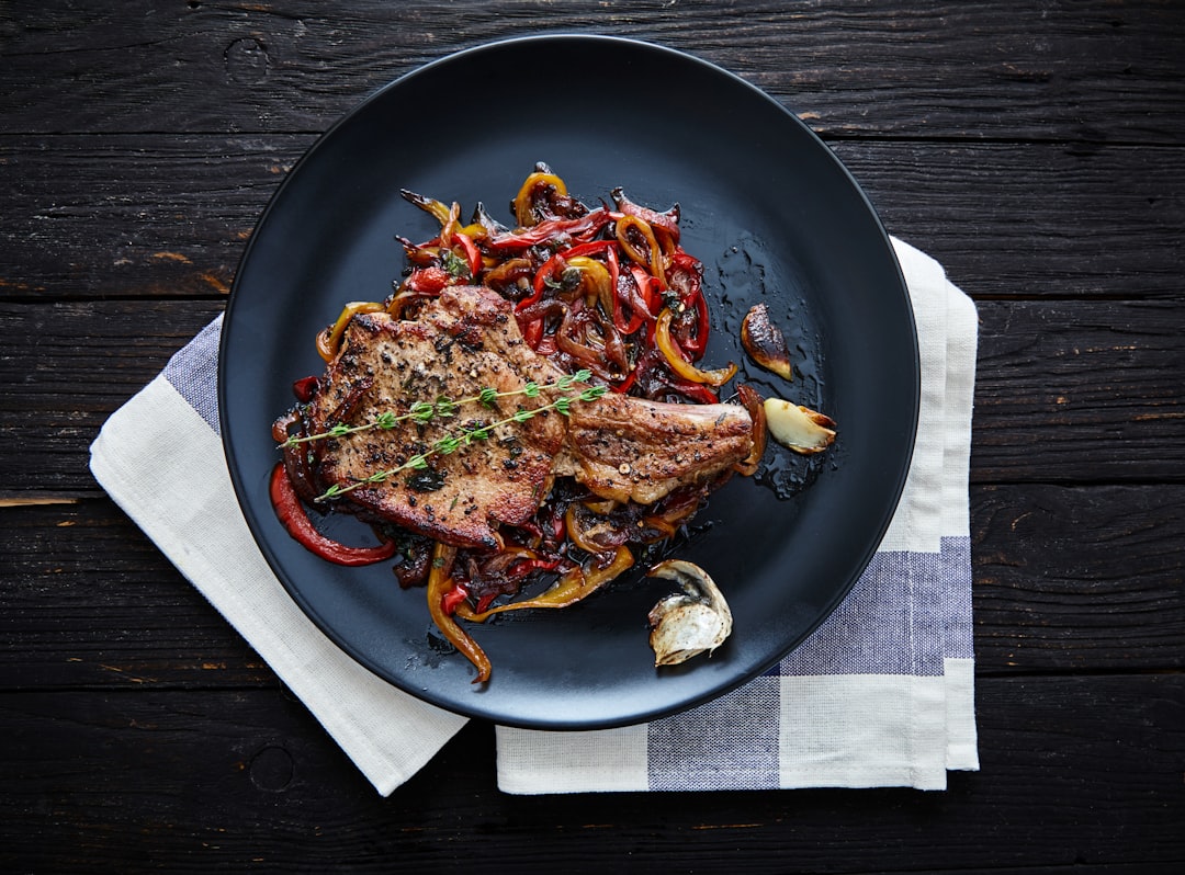Pan-roasted pork chops with fresh herbs, ready to be served with pan sauce