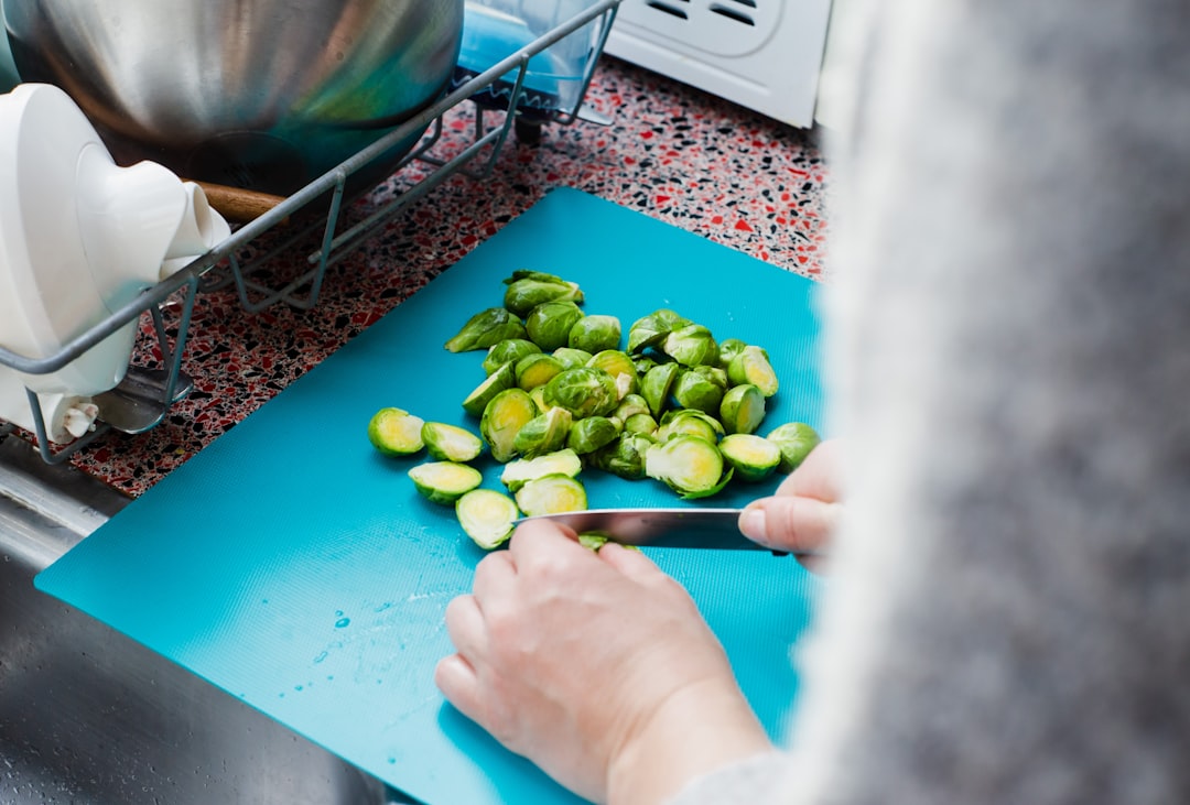 Chopping vegetables on a colorful plastic cutting board