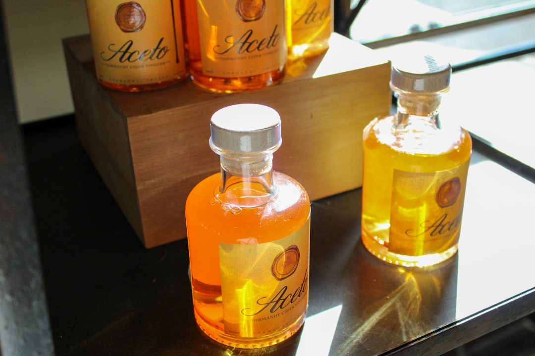 Glass bottles of vinegar lined up in a home kitchen