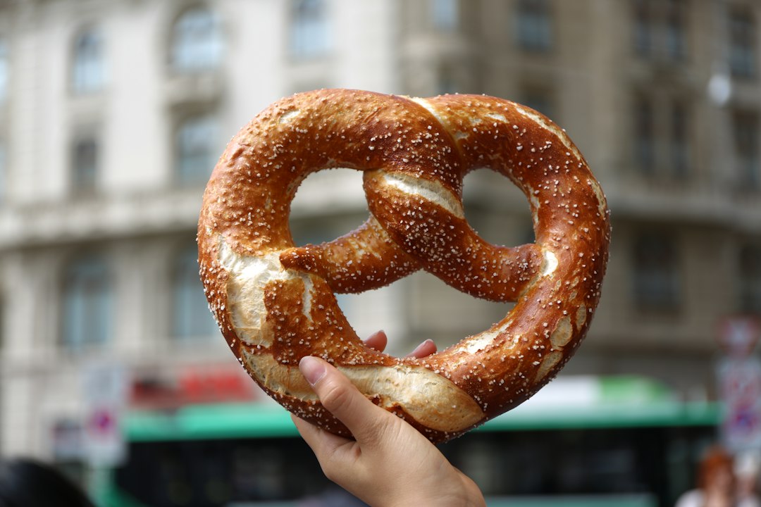 A classic salted soft pretzel held up fresh from the oven