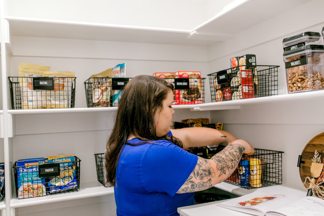 Sorting baking supplies into labeled baskets during a cabinet reset