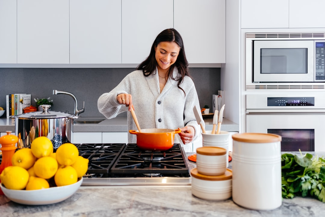 Home cook stirring a large pot on the stove