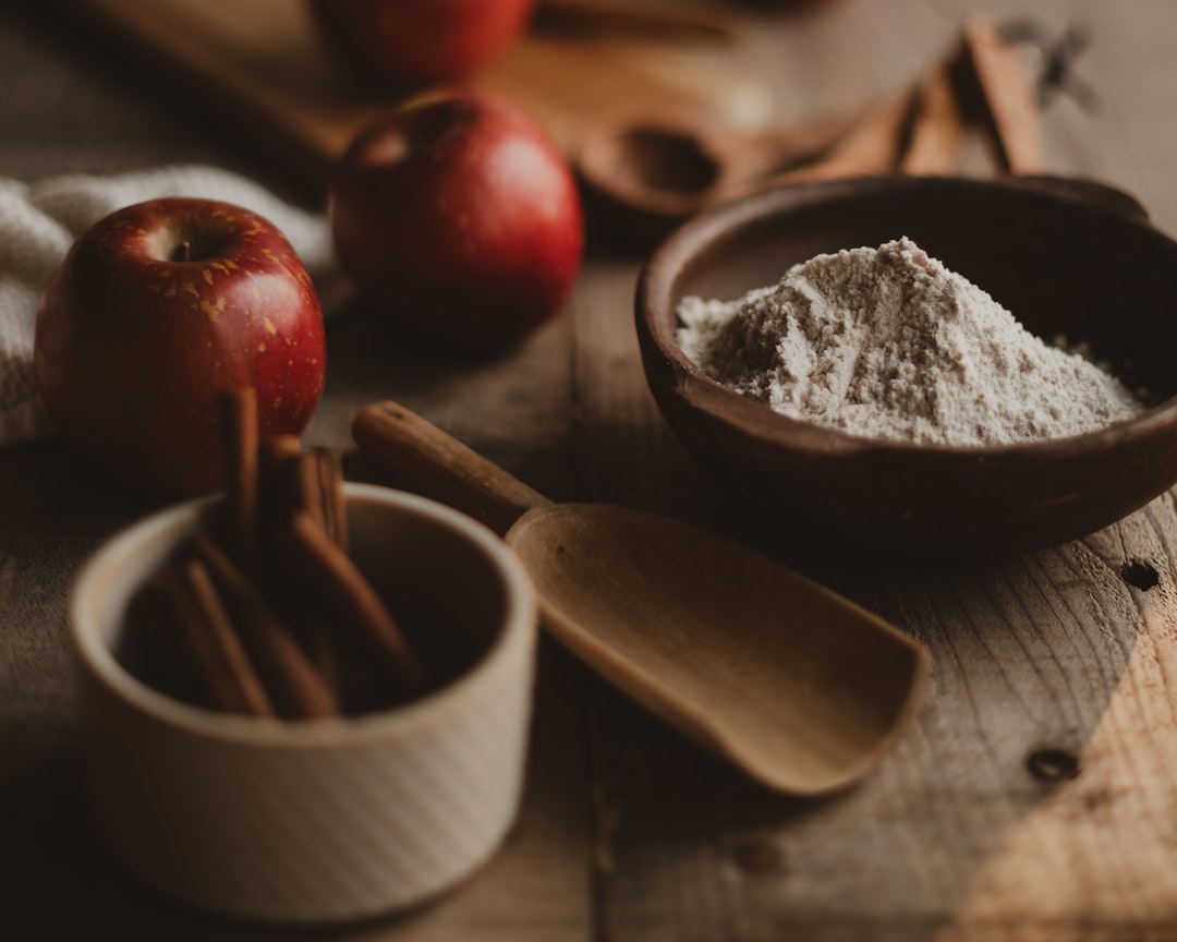 Fresh apples with cinnamon sticks and flour ready for sauce making