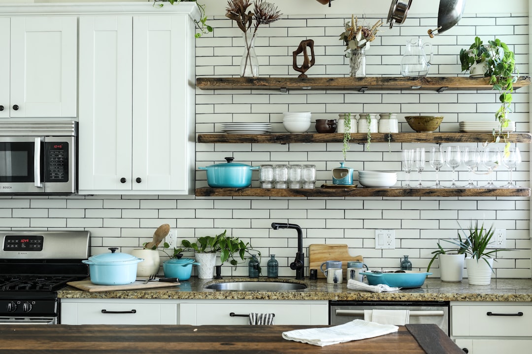 Bright kitchen cabinet shelves neatly arranged with dishware