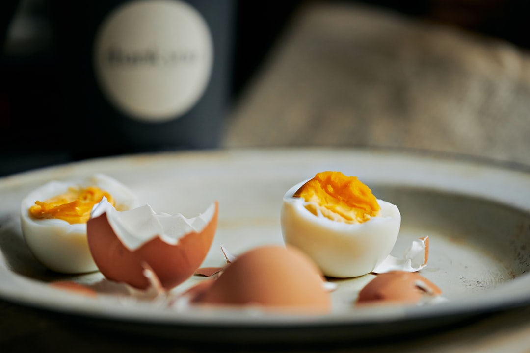 Soft boiled eggs with cracked shells on a plate