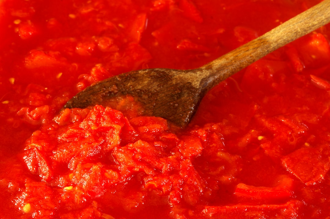 Tomato sauce gently simmering in a pot on the stove