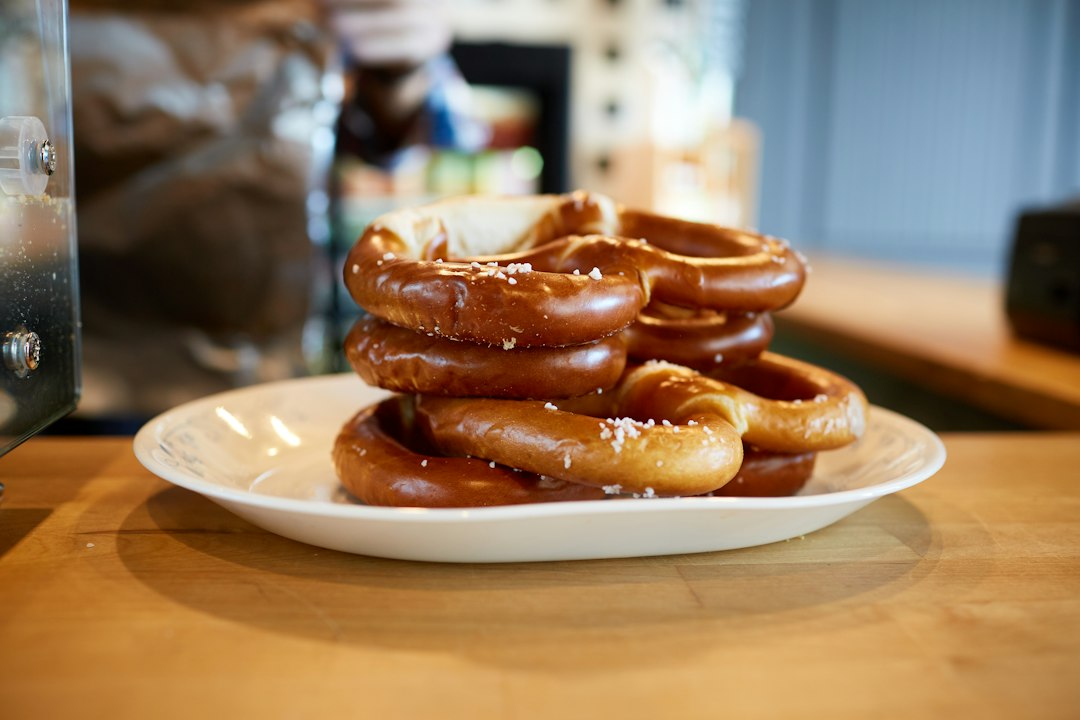 A stack of warm soft pretzels ready to serve beside the beer